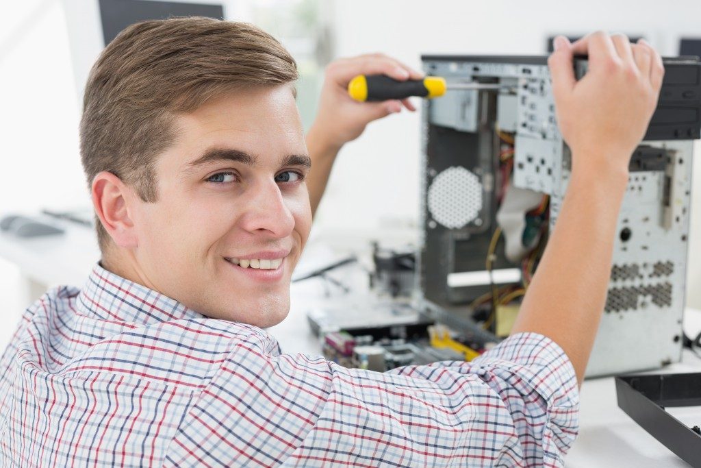 A smiling computer technician