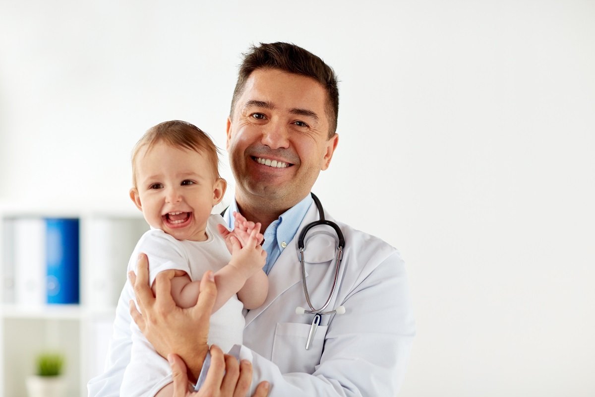 Pediatrician holding a baby