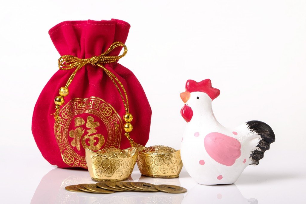 red money bag, gold and chinese coins on white background as New year concept