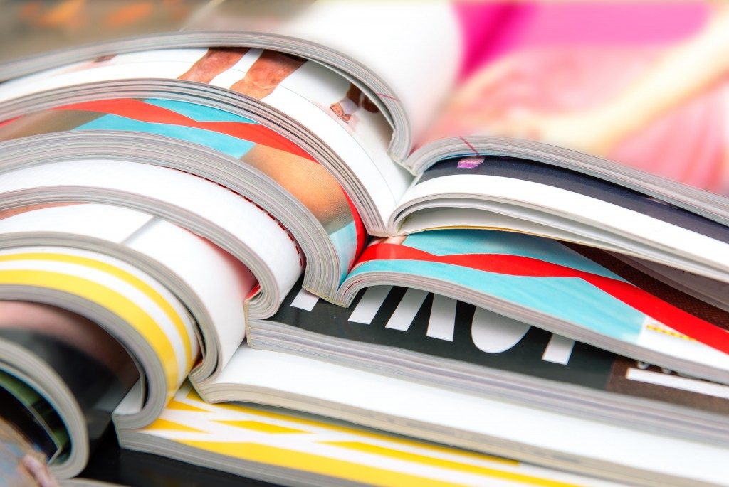 a stack of fashion magazines