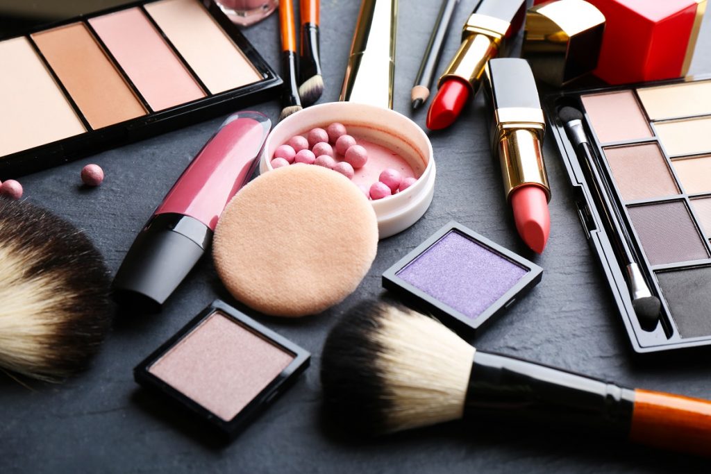 Make up, cosmetics scattered with black background