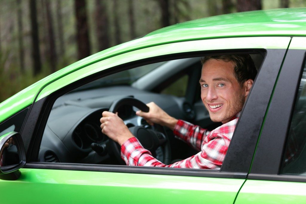 Man driving a bright green car