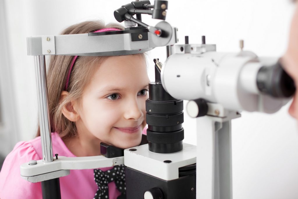 young girl having her eye checked