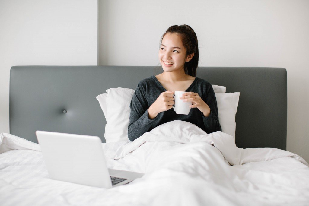woman with a cup in bed