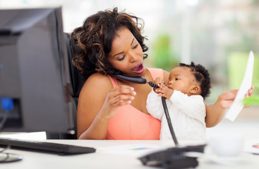 woman taking care of child while talking on the phone