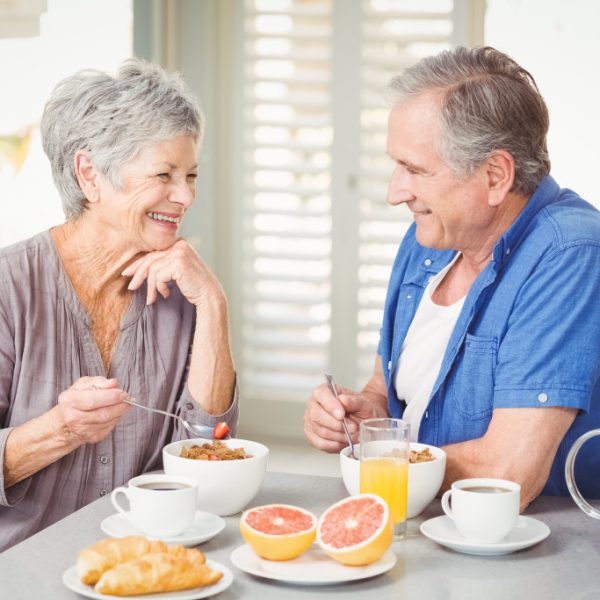 senior couple eating breakfast